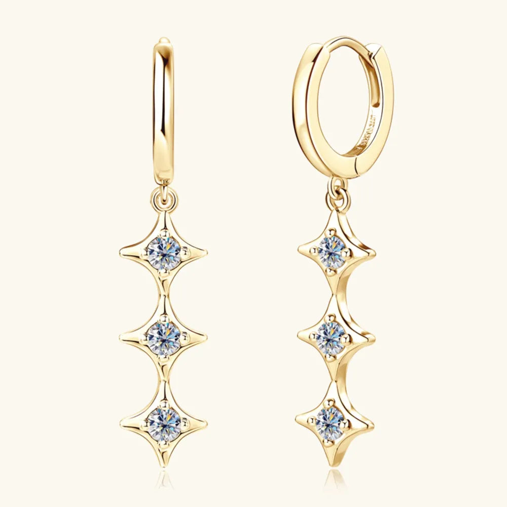 Gold hoop earrings with star-shaped gemstones on a white background