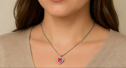 Necklace with a heart-shaped pink pendant worn by a person