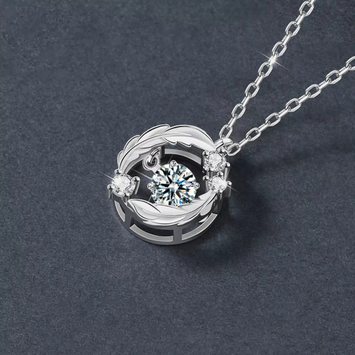 Silver necklace with a circular pendant featuring a central gemstone on a dark gray background