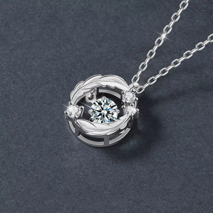 Silver necklace with a circular pendant featuring a central gemstone on a dark gray background