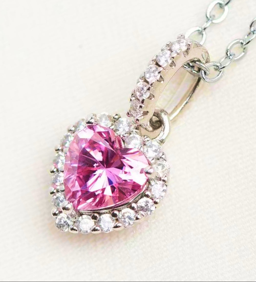 Pink heart-shaped gemstone pendant on a chain against a white background