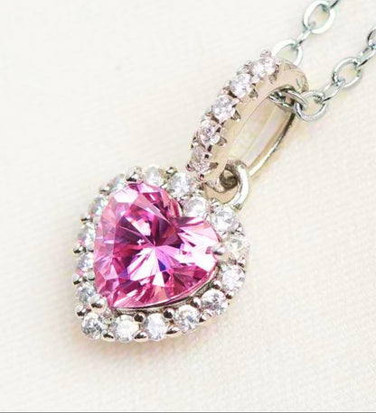 Pink heart-shaped gemstone pendant on a chain against a white background