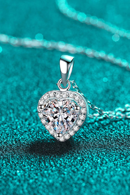 Heart-shaped diamond pendant on a turquoise background