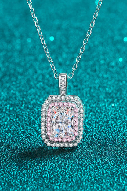 Diamond pendant necklace on a teal glittery background