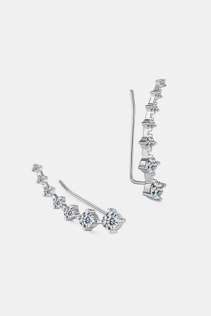 Pair of silver earrings with clear gemstones on a white background