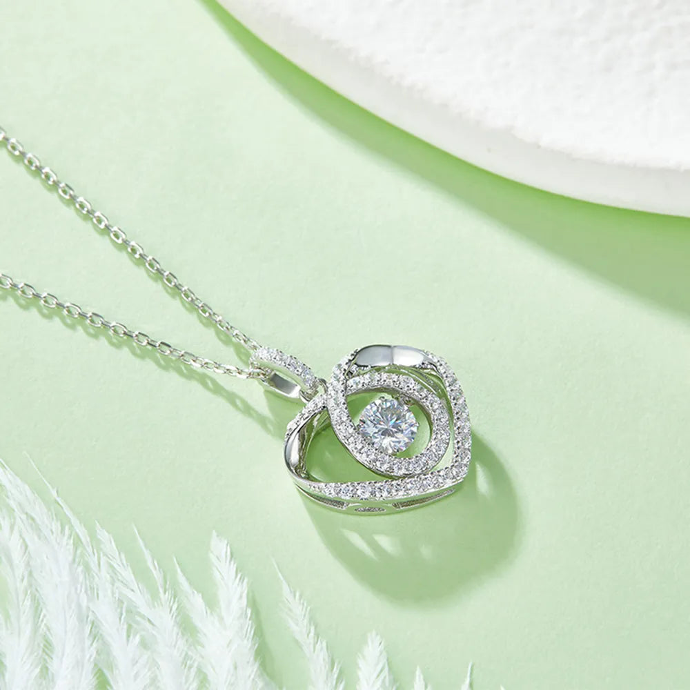 Silver necklace with a circular pendant on a light green background