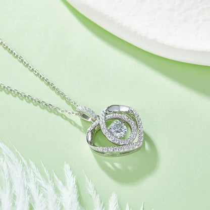 Silver necklace with a circular pendant on a light green background